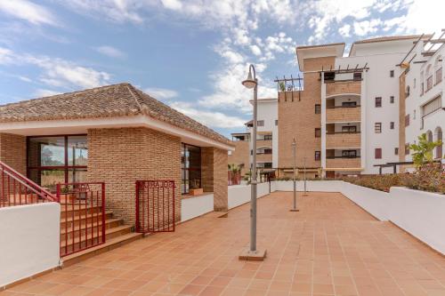 a walkway in front of a building at RentitSpain Terrazas del sol, Relax Piscina y Golf in Salobreña