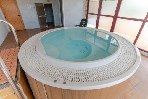 a jacuzzi tub in the middle of a room at RentitSpain Terrazas del sol, Relax Piscina y Golf in Salobreña