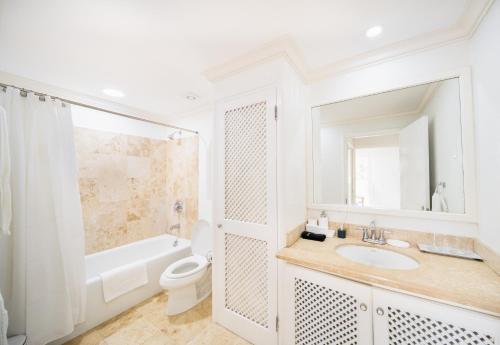 a white bathroom with a sink and a toilet at Sugar Hill Estate - B307 by Island Villas in Saint James