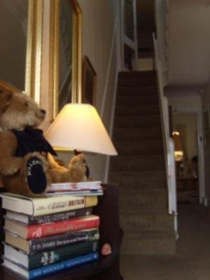 a teddy bear sitting on top of a stack of books at The Norwood Guest House in Southport