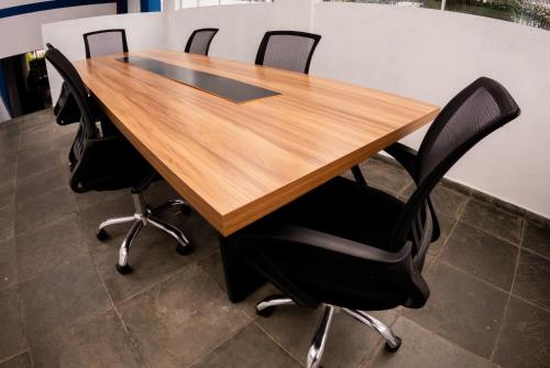 a wooden table with four black chairs around it at MOVA - Hotel Costa Azul in Ubatuba