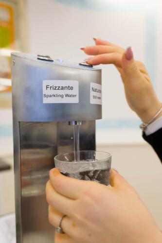 a person is holding a cup in a mixer at Hotel St Gregory Park in Rimini
