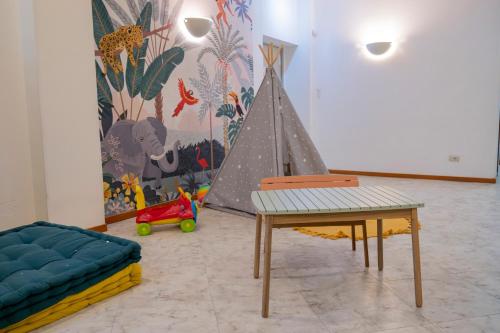 a room with a table and a toy pyramid at Hotel St Gregory Park in Rimini