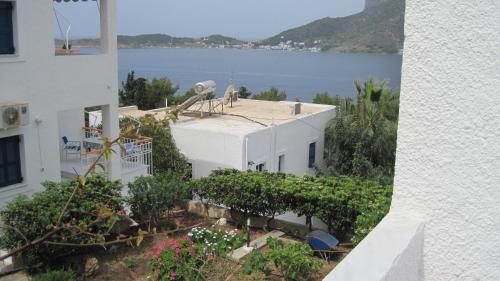 a white building with a view of the water at Tatsis Apartments in Masouri