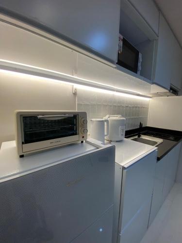 a small kitchen with a microwave on a counter at Elegant Escape Milano Bacoor Cavite in Bacoor