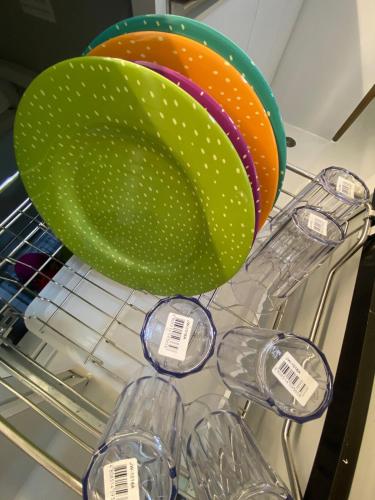a bunch of glasses and a large green bowl at Elegant Escape Milano Bacoor Cavite in Bacoor