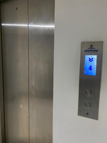 a metal elevator with a sign on a wall at Elegant Escape Milano Bacoor Cavite in Bacoor