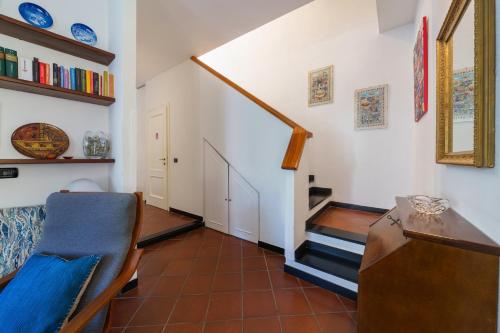 a living room with a staircase and a chair at Casa Marcone in Moneglia