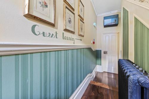 a room with a green wall and a bench at Vancouver Hotel and Studios in London