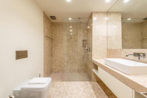 a bathroom with a toilet and a sink and a shower at GuestReady - Conde das Alcáçovas in Paço de Arcos