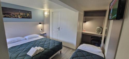 a hotel room with a bed and a flat screen tv at Fasthotel Roissy - Saint-Witz in Saint-Witz