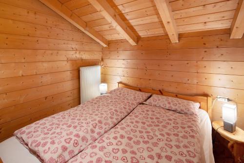 Ένα ή περισσότερα κρεβάτια σε δωμάτιο στο Agritur Ciasa Do Pare