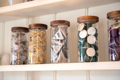 a shelf with glass jars filled with different items at The Fuzzy Duck in Newbold on Stour