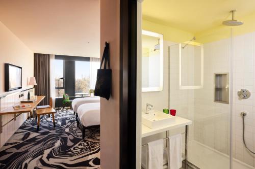 a hotel room with a bed and a bathroom at Mama Shelter Belgrade in Belgrade