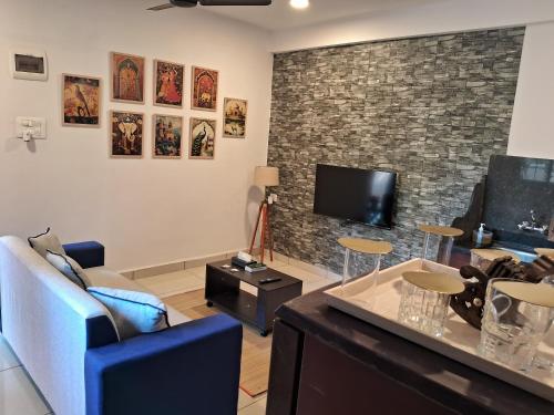 a living room with a couch and a tv at Arambol Bliss Hotel Apartments in Arambol