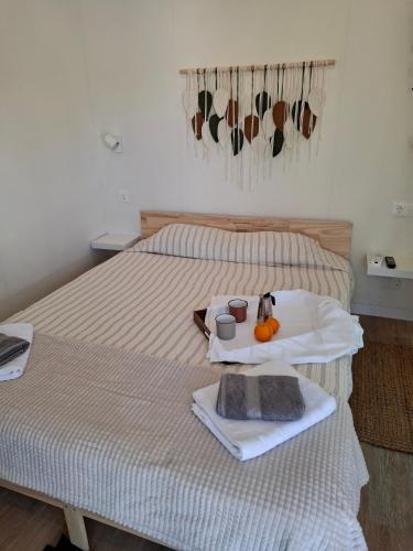a bedroom with a bed with a tray of food on it at Páteo da Memória Casa do Pintor in Quinta do Anjo