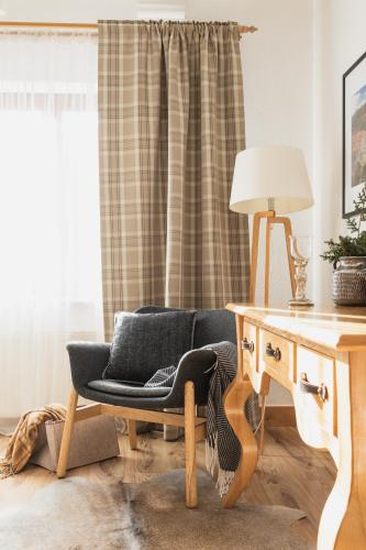 a living room with a chair and a desk at Domek Amicus in Zakopane