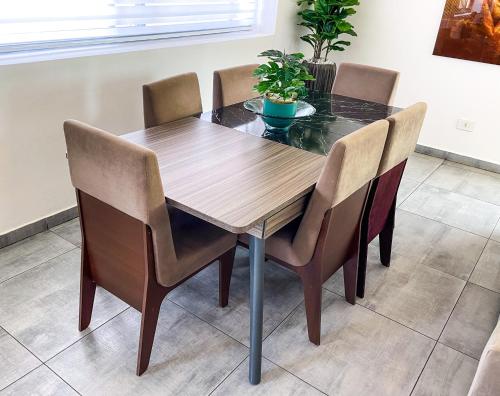 a dining room table with four chairs around it at Accra Luxury Apartments at Lul Water in Accra