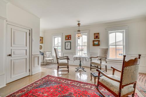 a living room with chairs and a grand piano at Walkable Main Street Location Spring Grove Apt in Spring Grove
