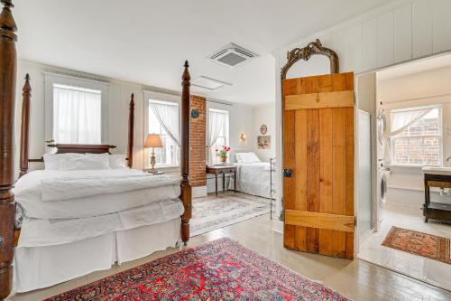 a bedroom with a large bed and a door at Walkable Main Street Location Spring Grove Apt in Spring Grove