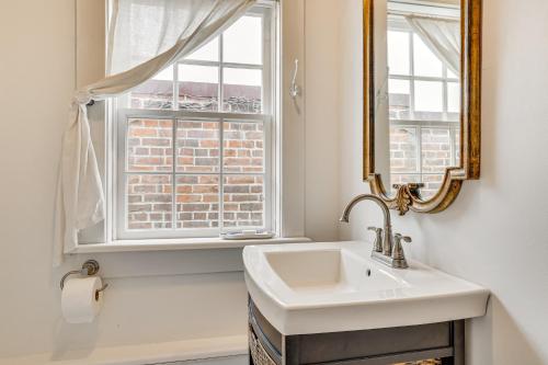 a bathroom with a sink and a window at Walkable Main Street Location Spring Grove Apt in Spring Grove