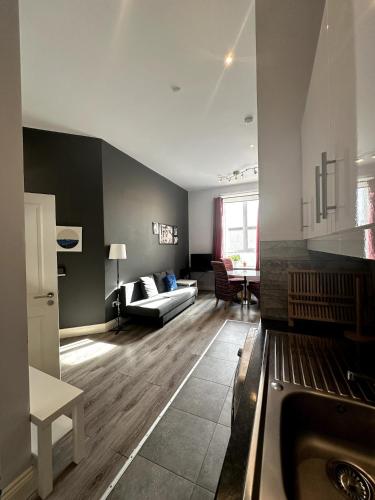 a kitchen and living room with a couch and a table at Abbey Apartments in Dublin