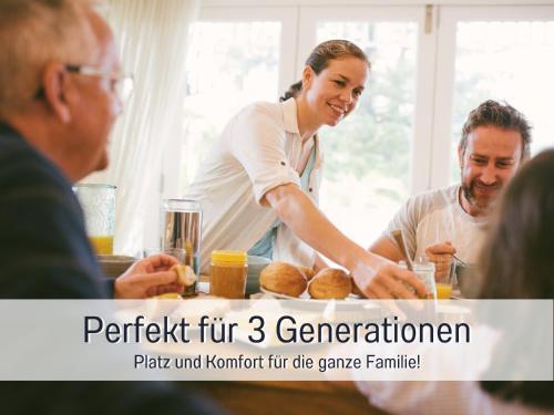 a woman and two men standing around a table at PENTHOUSE - 3 Schlafzimmer- sonnige Dachterrasse -Whirlpool & Alpenblick - Perfekt für Romantik oder Familienurlaub mit Kind, Hund willkommen - by FerienWohnenAmSee - in Überlingen