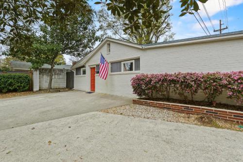 a house with an american flag in front of it at The Mid-Century Hub Close to Everything in Columbia