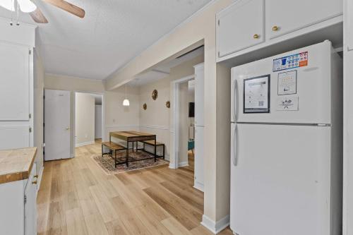 a kitchen and living room with a refrigerator and a table at The Mid-Century Hub Close to Everything in Columbia