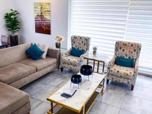 a living room with a couch and two chairs at Accra Luxury Apartments at Lul Water in Accra