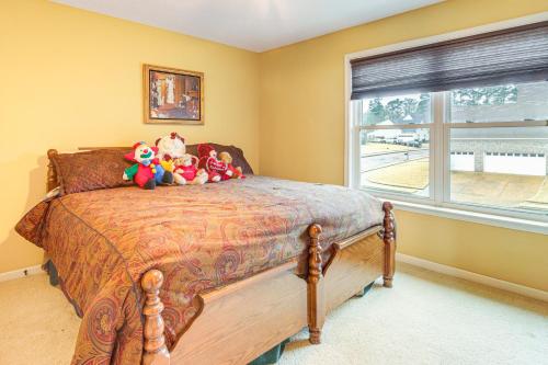 a bedroom with a bed with stuffed animals on it at Family-Friendly Gem with Home Office in Memphis in Olive Branch