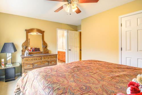 a bedroom with a bed and a dresser and a mirror at Family-Friendly Gem with Home Office in Memphis in Olive Branch