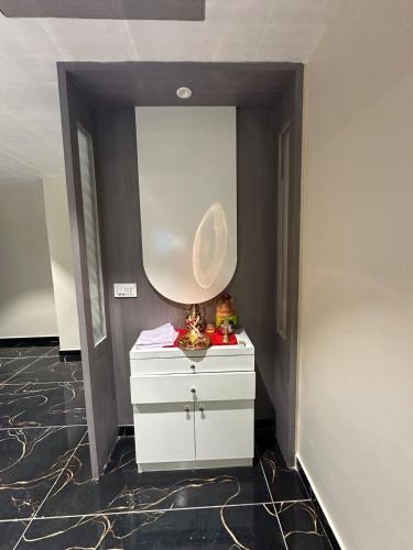 a hallway with a white dresser in a room at Hotel Shyam Paradise in Vadodara
