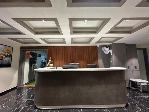an office lobby with a reception counter and chairs at Hotel Shyam Paradise in Vadodara