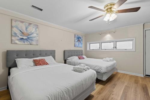 a bedroom with two beds and a ceiling fan at The Mid-Century Hub Close to Everything in Columbia