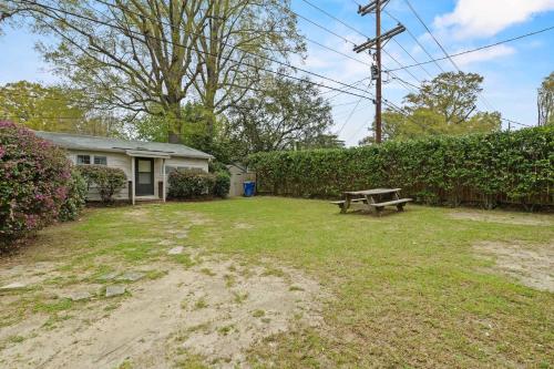 a backyard with a picnic bench and a house at The Mid-Century Hub Close to Everything in Columbia