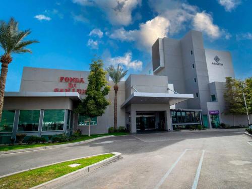 a parking lot in front of a building at Hotel Araiza San Luis R.C. in San Luis Río Colorado