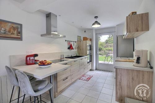 a kitchen with a counter with a bowl of fruit on it at Les dezees in Saint-Udy