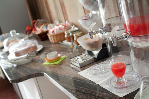 a counter top with a drink in a glass at Hotel Caselle in San Lazzaro di Savena