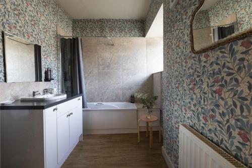 a bathroom with a sink and a bath tub at Bishop Lightfoot Cottage in Bishop Auckland
