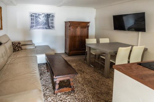 a living room with a couch and a table at Villa Backstein OBO19 in Schwerin