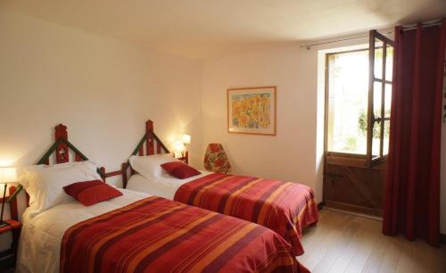 a hotel room with two beds and a window at Au clos de marie in Lusigny-sur-Barse