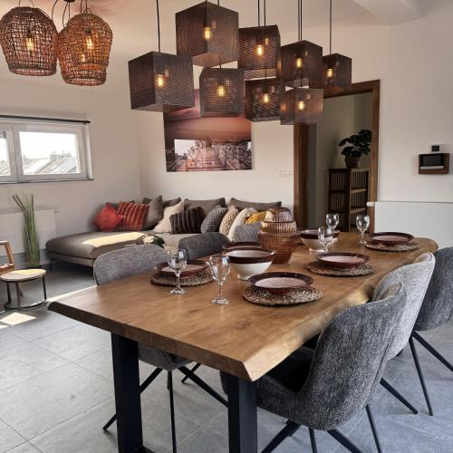 a dining room with a wooden table and chairs at Résidence Alissa Charleroi Airport in Charleroi