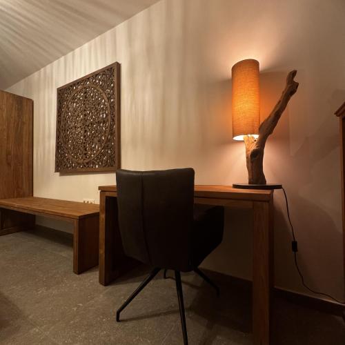 a desk with a chair and a lamp on it at Résidence Alissa Charleroi Airport in Charleroi