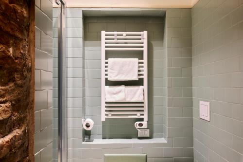 a bathroom with a towel rack and towels at Red Moon-Emme Loft in Milan