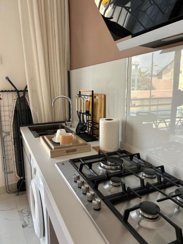 a kitchen with a stove top oven next to a window at Chambres d'Hôtes Centre Ville in Dakar