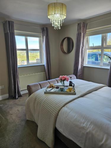 a bedroom with a bed with a tray of food on it at Doolin Vista House in Doolin