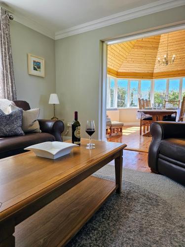 a living room with a table with a glass of wine at Doolin Vista House in Doolin