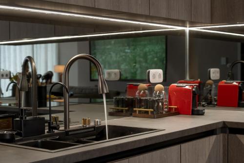 a kitchen counter with a sink and a mirror at Athens Soho Lofts -Evaggelistrias 18 in Athens