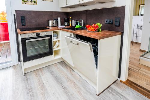 a kitchen with white cabinets and a counter top at Villa Backstein OBO19 in Schwerin